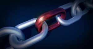 Closeup of metal chain with one red link