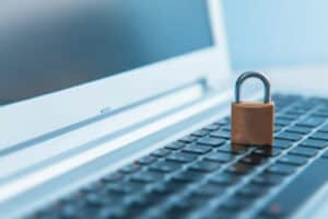 Padlock on laptop keyboard symbolising security.