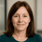 Smiling woman with brown hair indoors