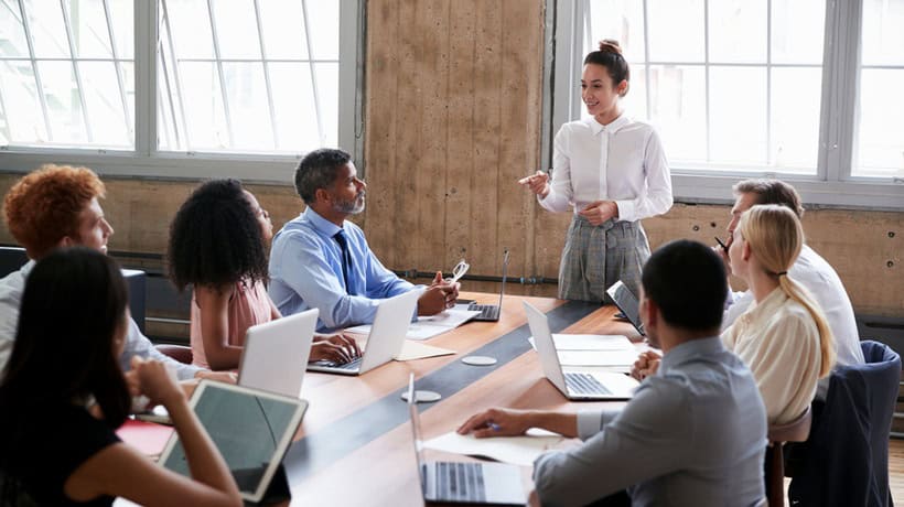 Team meeting with diverse professionals discussing strategy.