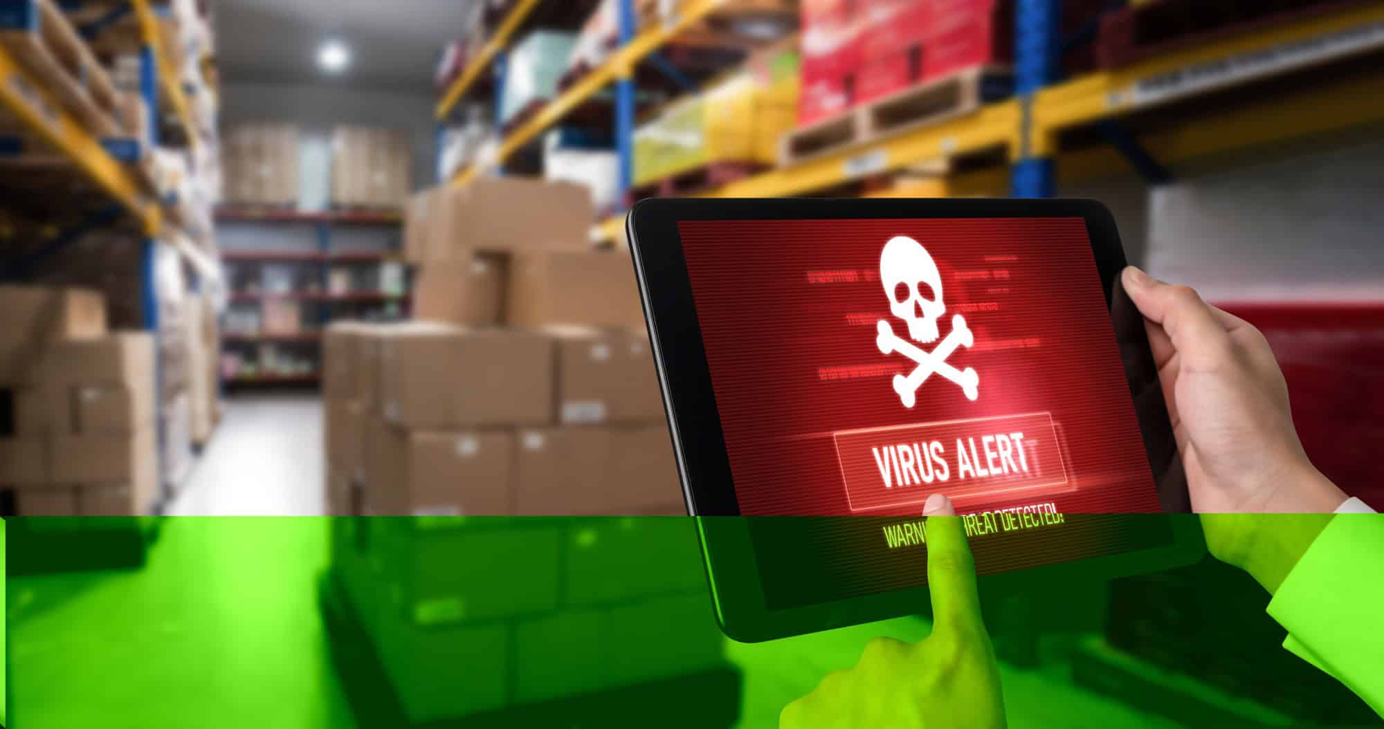 Tablet showing virus alert in warehouse.