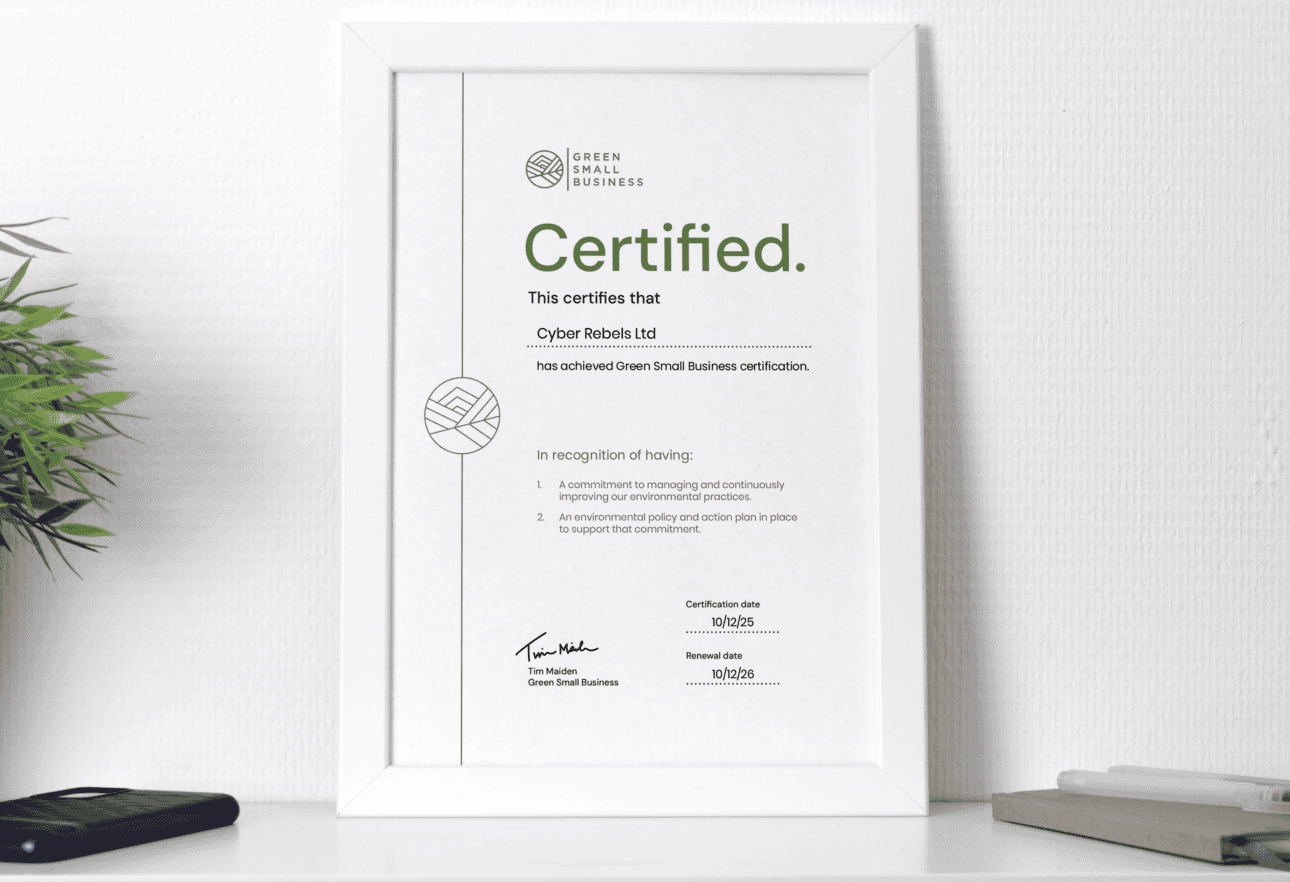 Certificate of Green Small Business achievement on shelf.