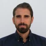 Man with a beard wearing a dark shirt.