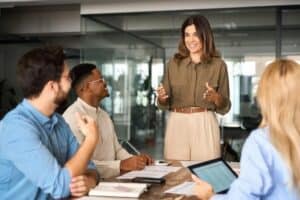 Team meeting with leader presenting ideas.