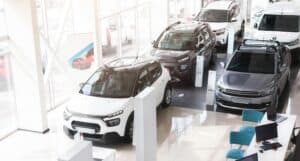 Modern car dealership showroom with various cars
