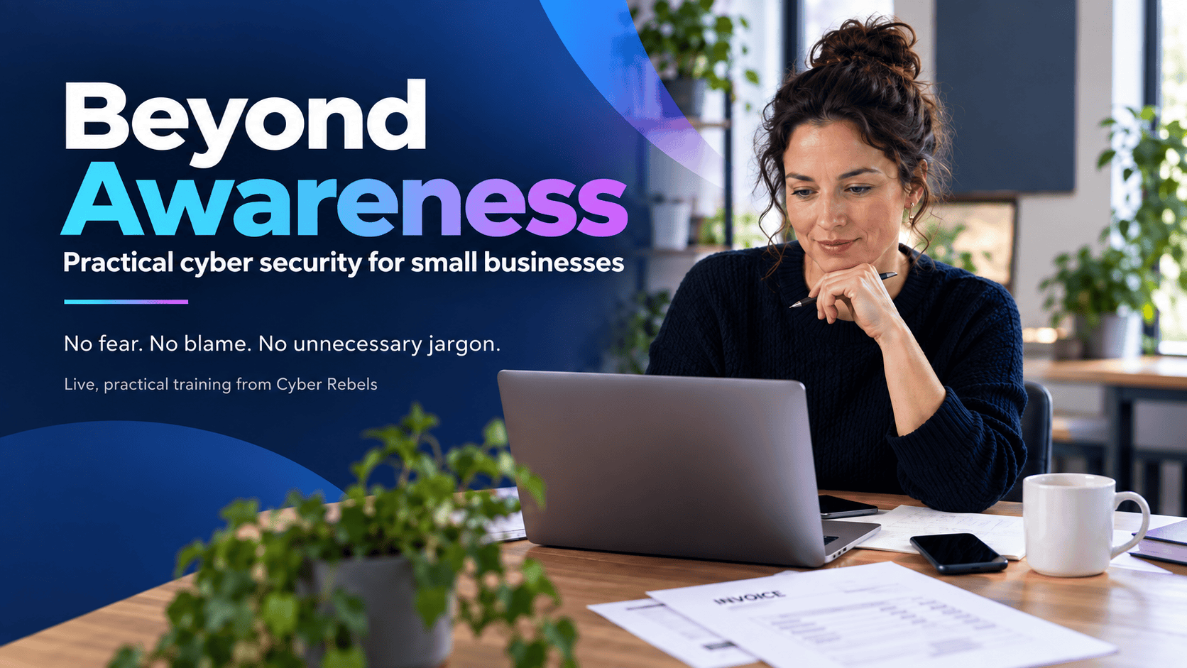 Woman working on a laptop with cybersecurity training materials on a desk.